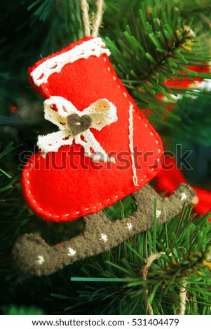 Christmas Tree decorated with toy ice skate made of felt.