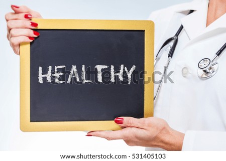 Healthy Chalkboard Sign Held By Female Doctor.