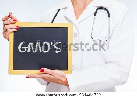 GMO's Chalkboard Sign Held By Female Doctor.