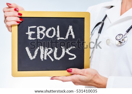 Ebola Virus Chalkboard Sign Held By Female Doctor.