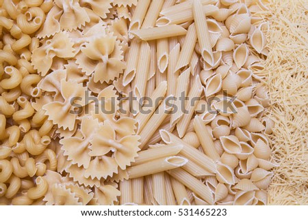 horns, feathers, bows pasta or macaroni and vermicelli background, texture Royalty-Free Stock Photo #531465223