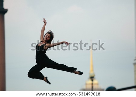 young and graceful woman performing gymnastic exercises in the air