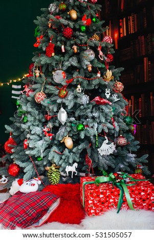The Christmas tree with presents stand in the center of room
