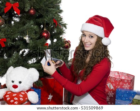 Teen by the christmas tree opening gifts on christmas morning image isolated on white background