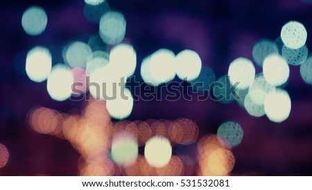 Colorful, blurred, bokeh lights background in cold tones. Abstract sparkles.