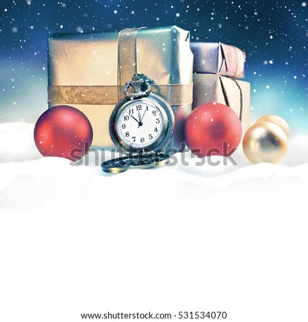 Christmas background with space for text. Christmas composition with gift boxes, christmas balls and vintage clock among snow