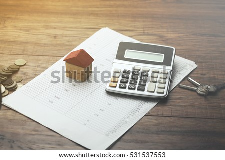house,calculator and key on document Royalty-Free Stock Photo #531537553