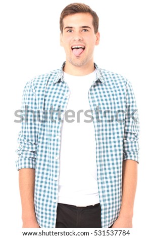 Portrait of a young handsome man showing tongue, face expression isolated on white. Copy space and template t shirt.