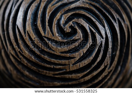 wooden object on black background