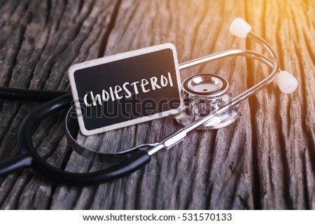 Medicine concept. Blackboard with word menopause and cholesterol on wooden background Royalty-Free Stock Photo #531570133