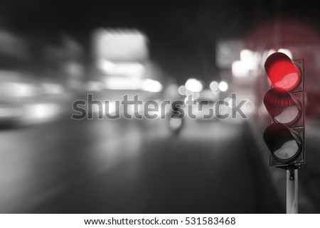 Red traffic light on the road in night city. dangerous signal stop crash driving highway,expressway; Blurred background of car dark fast truck surveillance security with semaphore. safety street