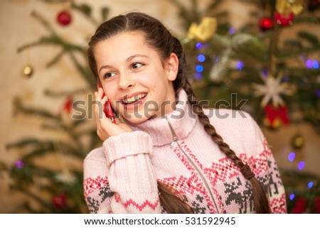 girl with mobile phone near a tree