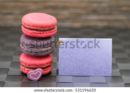 Sweet and colorful macaroons cookies and card with blank space,selective focus.