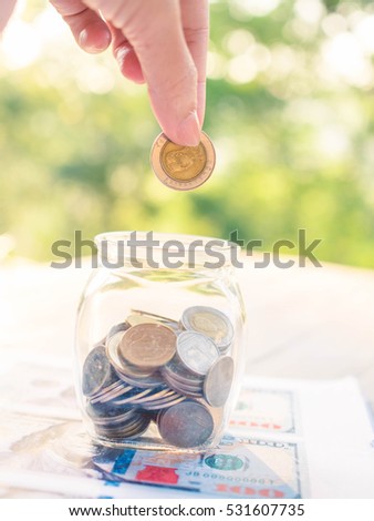 putting coins concept of banking, finance and savings.