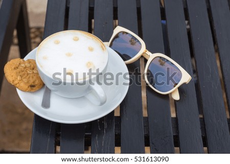 Coffee with glasses on a wooden table.