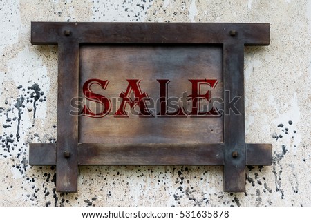 Black and grey wooden board on wall with words of "sale"