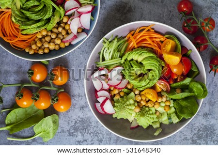 Buddha bowl of mixed vegetable with avocado, carrots, spinach, romsnesco cauliflower and radishes  Royalty-Free Stock Photo #531648340