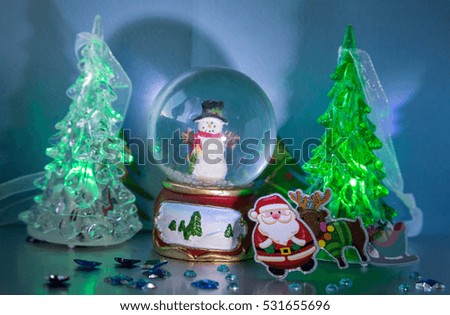 Santa Claus with reindeer and sleigh with gifts, snowman, glowing trees and stars - Card