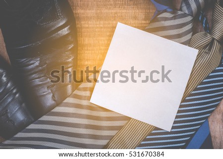 Necktie and shoes on grunge wood background