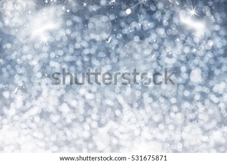 Magic sparkling holiday abstract glitter background with fireworks blinking stars and falling snowflakes. Blurred bokeh of Christmas lights.