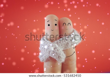 Two fingers are decorated as cute couple in the winter. Suitable to be used to promote anything about winter.