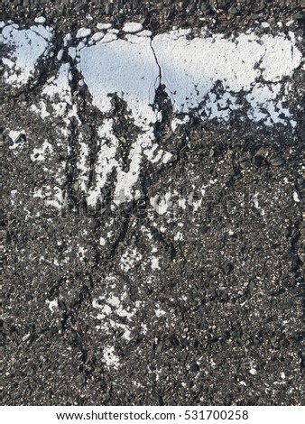 Cracked of white line on old asphalt road/ Texture background