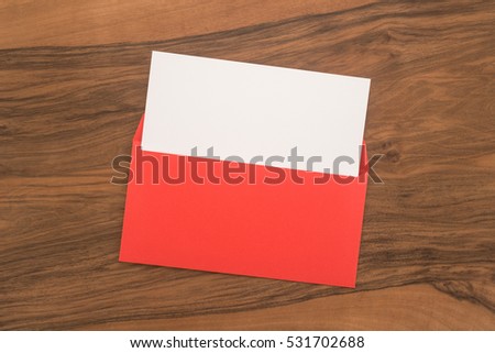 Blank paper and envelope on wooden background 
