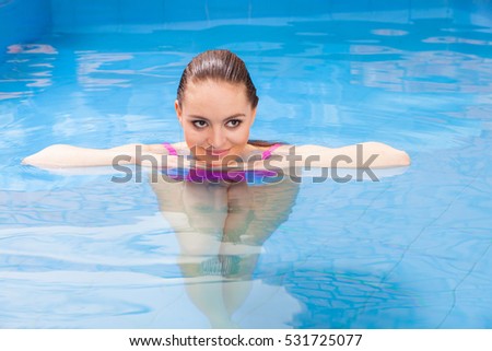 Relax, spa hotel, resort concept. Charming woman having fun in swimming pool, relaxing enjoying the water
