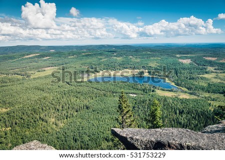 View of a lake in the form of a large footprint. Picture taken from the top of a high mountain in northern Sweden