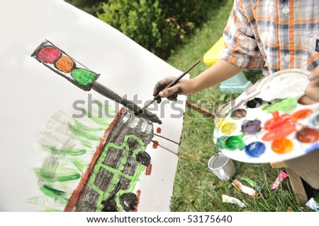 Kid playing and drawing outdoor, traffic light