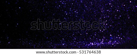 glitter vintage lights background. purple and black. defocused.