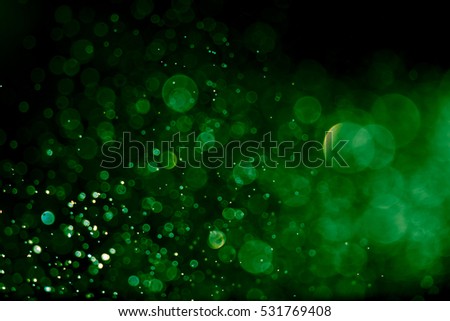 Bokeh green on a black background. Blur and bokeh abstract , vibrant colors and textured. Royalty-Free Stock Photo #531769408