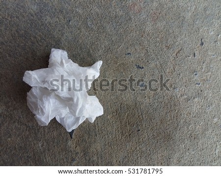crumpled tissue paper on concrete background