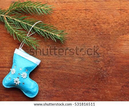 Christmas green pine fir spruce branch and blue toy socks on old vintage rustic wooden background with copy space