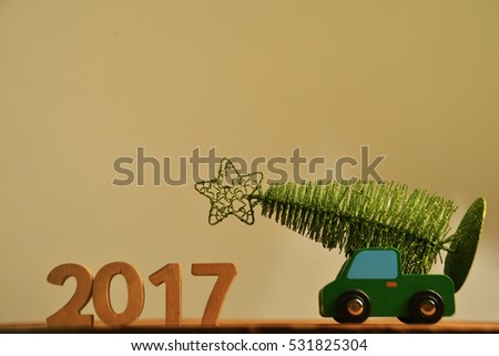 green Christmas tree on red toy car. Christmas holiday celebration concept. empty copy space for inscription. Holiday background. 2017 happy new year. wooden sign. 