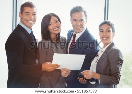 Portrait of business people standing together at office