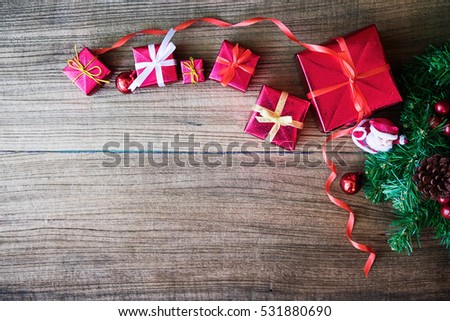 Christmas background with decorations and gift boxes on wooden board.