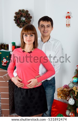 picture of romantic couple with gift boxes. happy man and woman hugging in Christmas