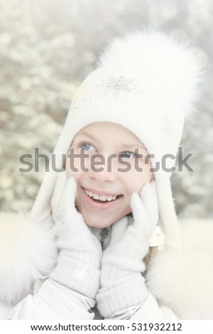 Happy cute little girl surprised the first winter snow