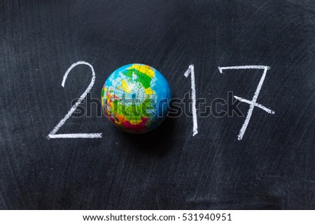 drawing 2017 and map/Human hand write white text on blackboard