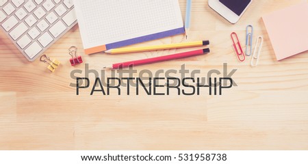 Business Workplace with  PARTNERSHIP Concept on Wooden Background