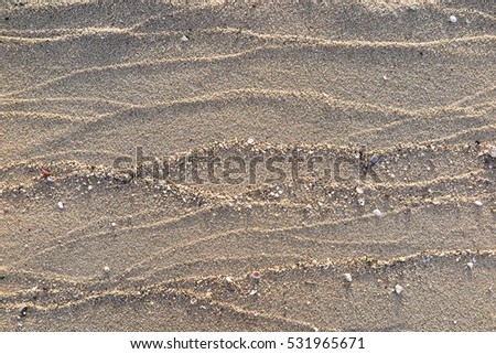 Patterns Texture of sand on the beach Royalty-Free Stock Photo #531965671