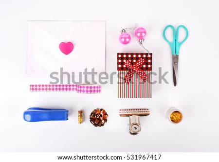View top, Flat lay.Stationery with gift. Envelope and heart gold confetti, scissors, stapler, bump.