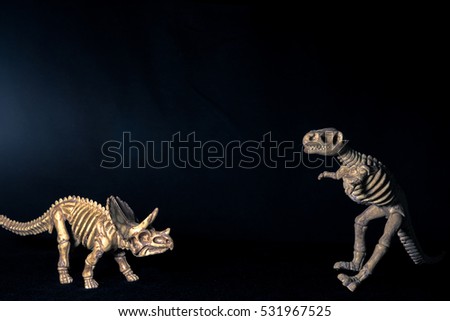 dinosaur skeleton isolated on black background. Dark tone picture style with free space for texting.