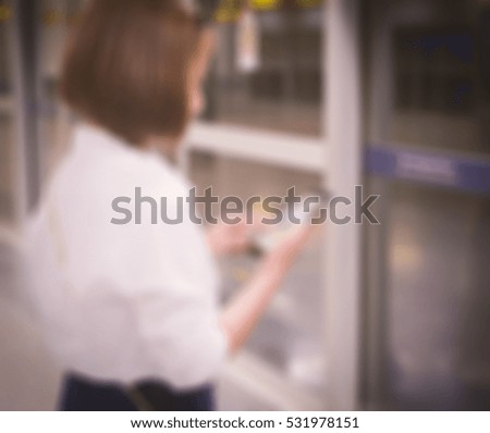hand using smartphone with blank screen on underground blur background