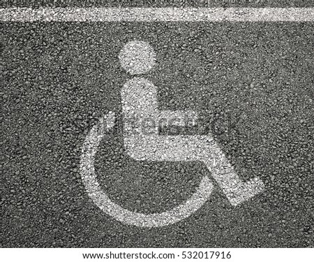 Disabled parking sign on asphalt