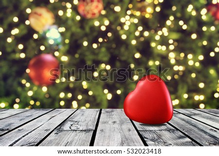Red heart on wooden table with christmas light night,abstract circular bokeh background