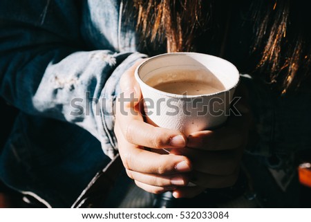 Young Asian Girl Holding Hot Coffee Chocolate Cup in the Hand