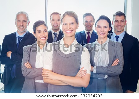 Team of businesspeople posing together in the office