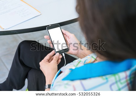 Business concept with BLANK SCREEN mobile phone. Woman with modern mobile phone in hands
FEMale hand holding black cellphone WITH SCREEN FOR COPY SPACE